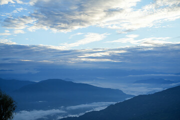 In the distance, mountains and clouds merge together.