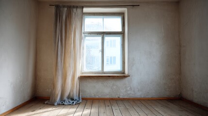 Empty room with old wooden floor and sheer curtain at window.