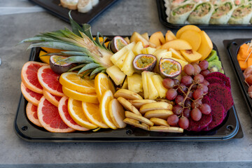 Vibrant fruit platter featuring a variety of fresh tropical and seasonal fruits during a sunny afternoon gathering