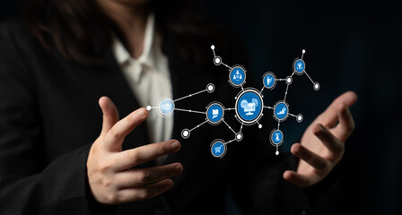 Professional individual presenting digital icons related to technology and data, symbolizing innovation and connection in a modern business environment. Tessel
