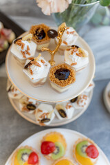 Delicious assortment of desserts served on elegant tiered dessert stand at a spring gathering