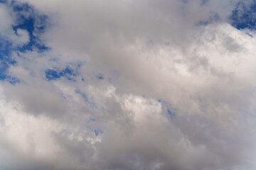 Fototapeta premium Clouds drift gracefully across a blue sky during a calm afternoon