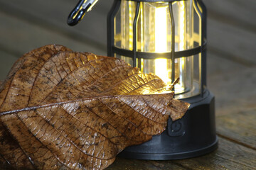 lantern and a autumn leaf on the table