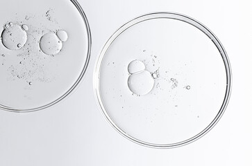 The texture of a cosmetic serum or body gel in a Petri dish.