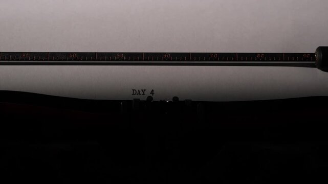 Close up of an antique manual typewriter striking day 4 on white paper, evoking steady progress, creative routine, nostalgia, and the ongoing writing journey