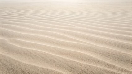 Fototapeta premium Rippled Sand Dunes Under Bright Sunlight Creating Abstract Natural Texture Background