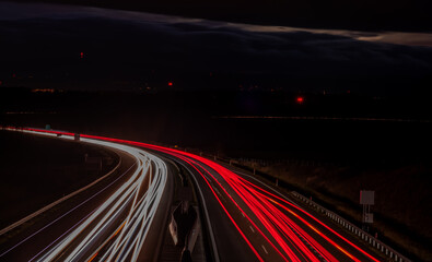 Color cars lines on dark highway from Prague to Linz near Chotycany village