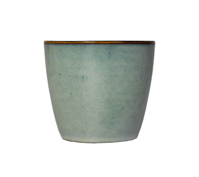 ceramic cup with a smooth tapered form and muted turquoise glaze stands isolated on a bright