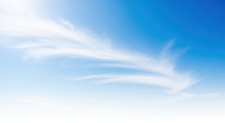 Wispy white clouds drifting in a clear blue sky