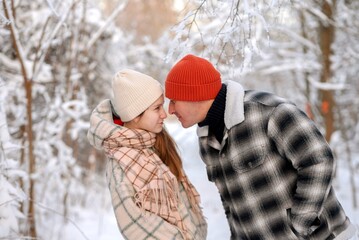 Father and daughter playing and enjoying the snow in a winter forest. Concept of family joy, warm emotions, childlike happiness, and fun winter activities outdoors.
