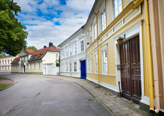 Old wooden colorful buildings on Kyrkogatan street in Gävle, Sweden