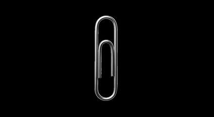 Obraz premium Closeup view of a silver paperclip on a black background, symbolizing connection and attachment