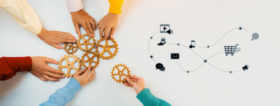 Hands engage with gears symbolizing teamwork and strategy, combined with digital marketing icons to illustrate collaboration in modern business environments. Trope