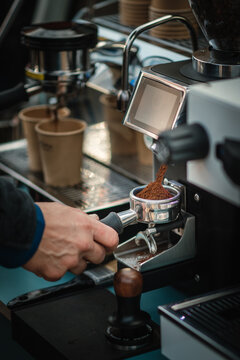 Frisch gemahlener Kaffee f&auml;llt in einen Siebtr&auml;ger
