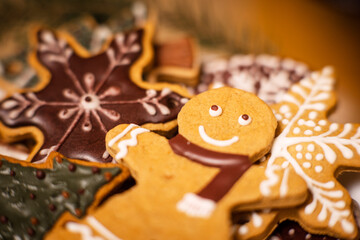 Lots of gingerbread cookies for Christmas in a plate on a dark background. Homemade gingerbread cookies for Christmas holiday