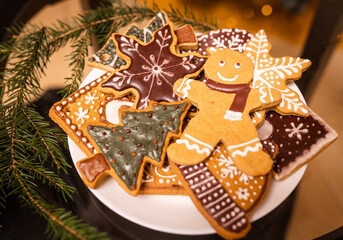 Lots of gingerbread cookies for Christmas in a plate on a dark background. Homemade gingerbread cookies for Christmas holiday