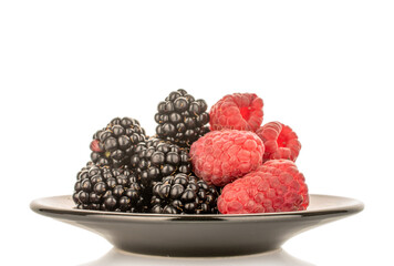 Sweet raspberries and blackberries isolated on white background, macro.