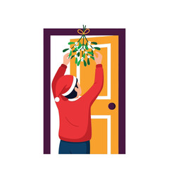 Holiday cheer Boy hangs mistletoe above the door for Christmas kiss
