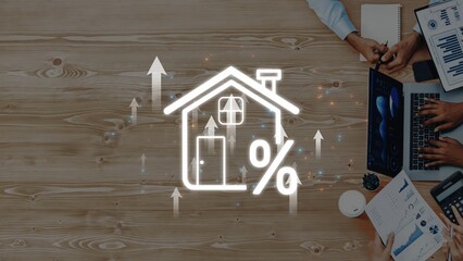 This stock photo showcases a business meeting focused on real estate growth, featuring a home icon...