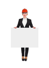 A businesswoman engineer stands in an orange helmet and holding blank poster.