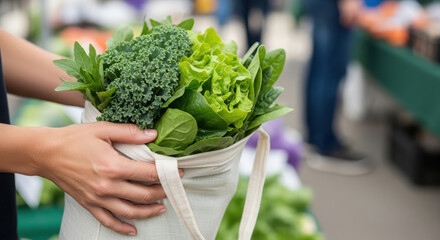 Person holding a reusable bag filled with fresh green leafy vegetables at a market