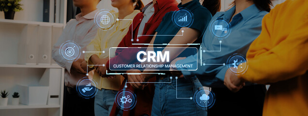 A diverse group of professionals models teamwork while showcasing the CRM concept and customer relationship management icons, symbolizing effective collaboration in a modern workplace. Trope