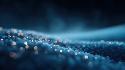 Abstract close-up image of glowing blue bokeh lights on smooth surface creating dreamy and serene background for various creative projects