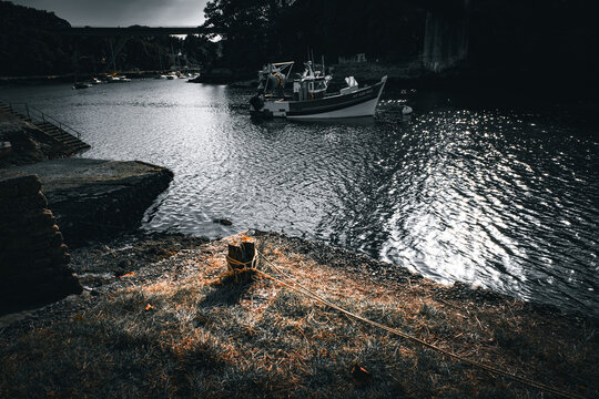 A boat is floating in the water near a dock