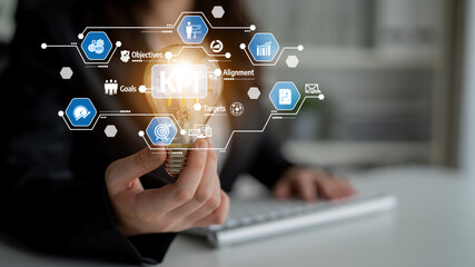 A businesswoman presents a light bulb symbolizing innovation, surrounded by digital icons representing KPIs, strategy, and analytics in a modern office setting. Tessel