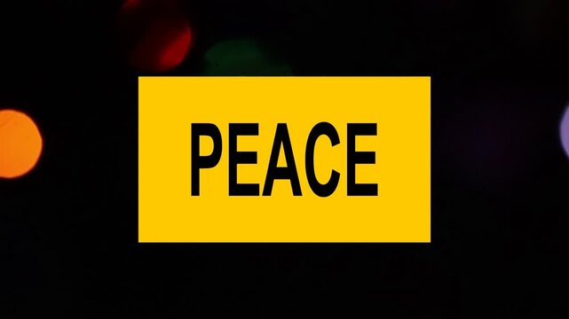 Un primer plano de una nota con la palabra paz en un fondo de luces de colores desenfocadas