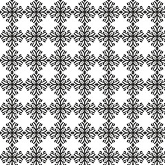Intricate black snowflake pattern on white background repeating geometric winter holiday design
