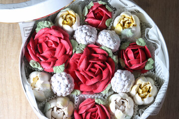 Marshmallow flowers in a hat box, marshmallow tulips and roses, homemade marshmallow, top view.