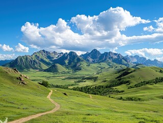 Fototapeta premium Expansive green rolling hills and dramatic jagged mountain range under a vibrant blue sky with fluffy white clouds, featuring a winding dirt path leading through the landscape.