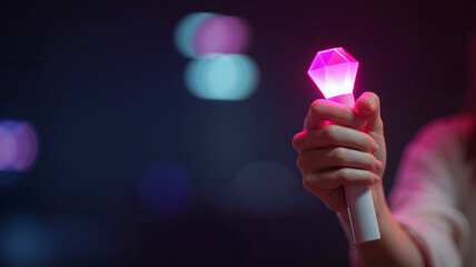 female hand tightly clutching minimalist white lightstick glowing neon pink and magenta, set against a dark ambient background with high contrast