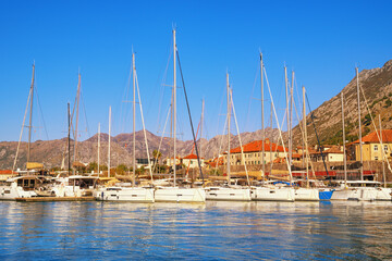 Obraz premium Sailboats in port near Kotor Old Town on sunny autumn day. Bay of Kotor, Montenegro