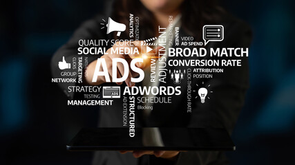 A business professional presents a tablet displaying various marketing terms, emphasizing the essentials of digital advertising and effective campaign management. Tessel