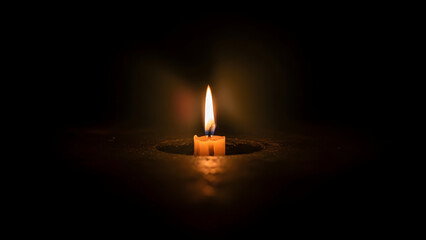 Single Candle Flame Glowing in Complete Darkness