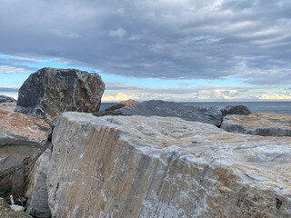 Coastal boulders and dramatic sky near ocean