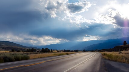 Scenic road journey under a blue sky evokes peaceful travel inspiration and serene landscape imagery