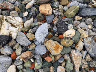 Colorful assortment of natural rocks and pebbles on a beach