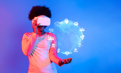 A person wearing a virtual reality headset engages with holographic representations of a digital world filled with various technology-related icons and symbols. XDMCP