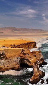 Vertical aerial drone view of the Pacific Ocean and cliffs in Paracas. Dramatic Pacific landscape. Panoramic coastal view. Peru. Region Ica.