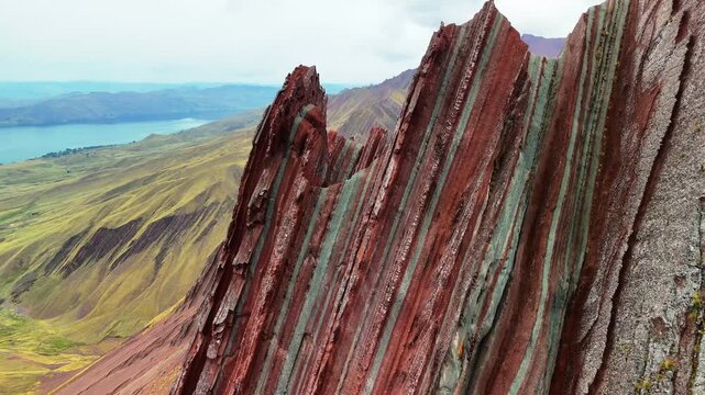 Aerial drone view of Pallay Punchu with multicolored ridges. At 4,791 meters, people enjoy the summit view. Cusco, Peru	