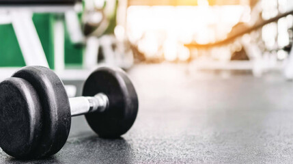 Dumbbell sitting on the gym floor, symbolizing strength, health, and dedication to a healthy lifestyle and training