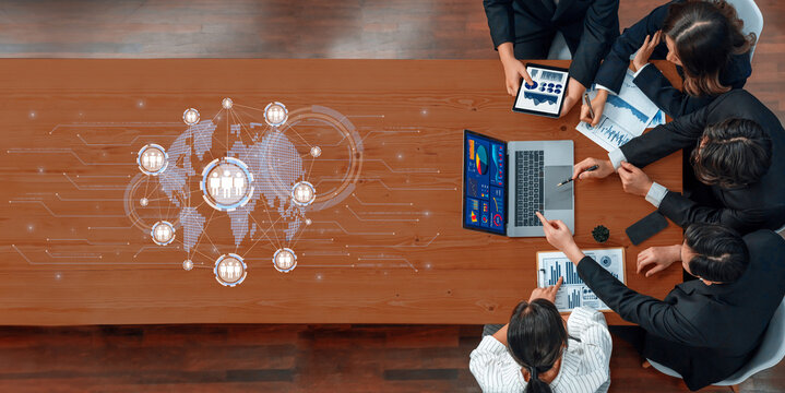 A diverse team collaborates in a modern business meeting, utilizing digital data visualization to enhance strategy planning and discussion of global connectivity. Trope