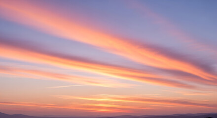 Pastel Sunset Sky with Layered Pink and Orange Clouds Creates Dramatic View Over Mountain Range Revealing Tranquil Beauty and Peaceful Landscape