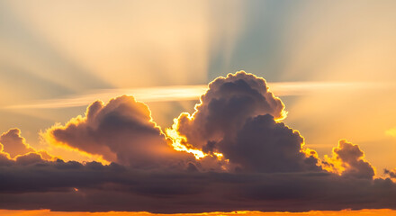 Dramatic Sky at Sunset with Sun Rays Shining Through Clouds Creates Beautiful Atmospheric Scenery and Golden Light Enhancing the Beauty of Nature