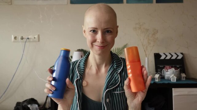 Bald female patient selecting sunscreen lotion, focus on daily skincare, UV protection, and cancer prevention awareness.