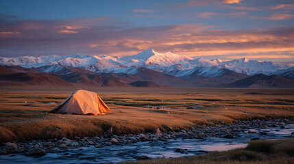 sunset scenery of snow-capped mountains and tents in winter