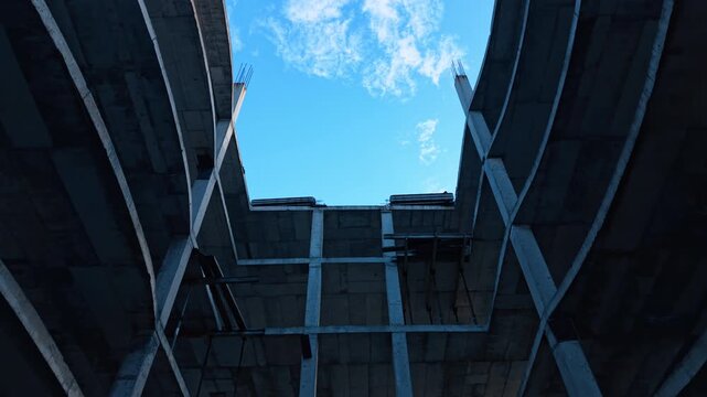 Rising in the open space inside the multi-storied building. Going up to the top of the construction structure.